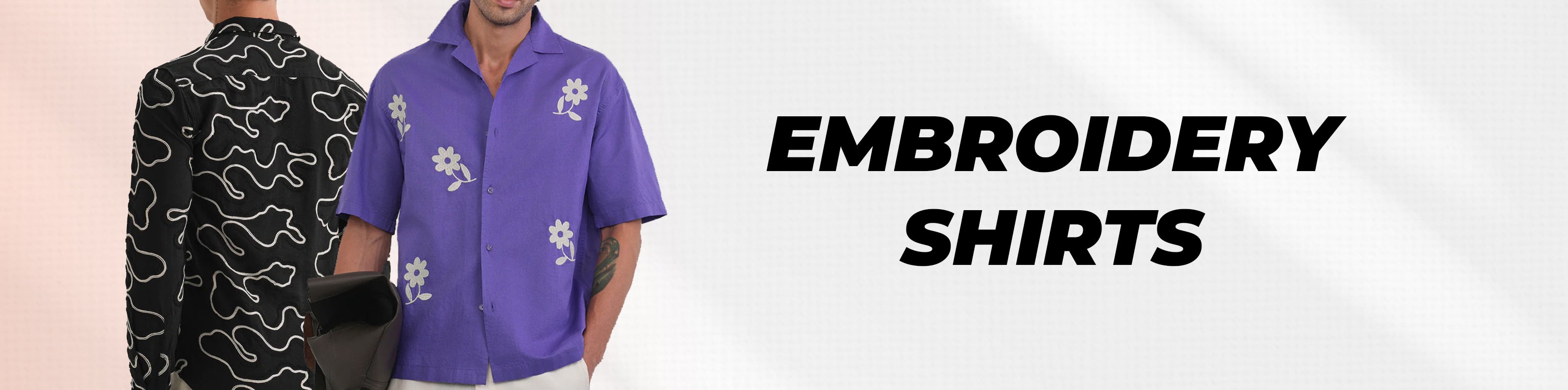 Two men modeling embroidered short-sleeve shirts side by side, with large black text reading 'EMBROIDERY SHIRTS' on a light background. One shirt is black with white embroidery, and the other is purple with white embroidery.