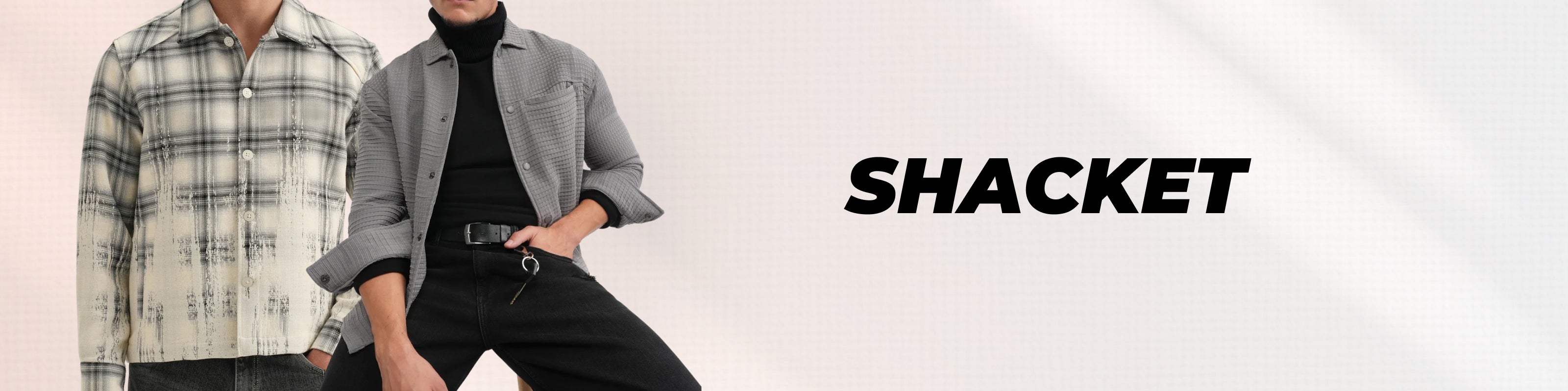 A person wearing a light gray shacket over a black turtleneck and black pants, posed against a light gray background with the word 'SHACKET' printed on the right.