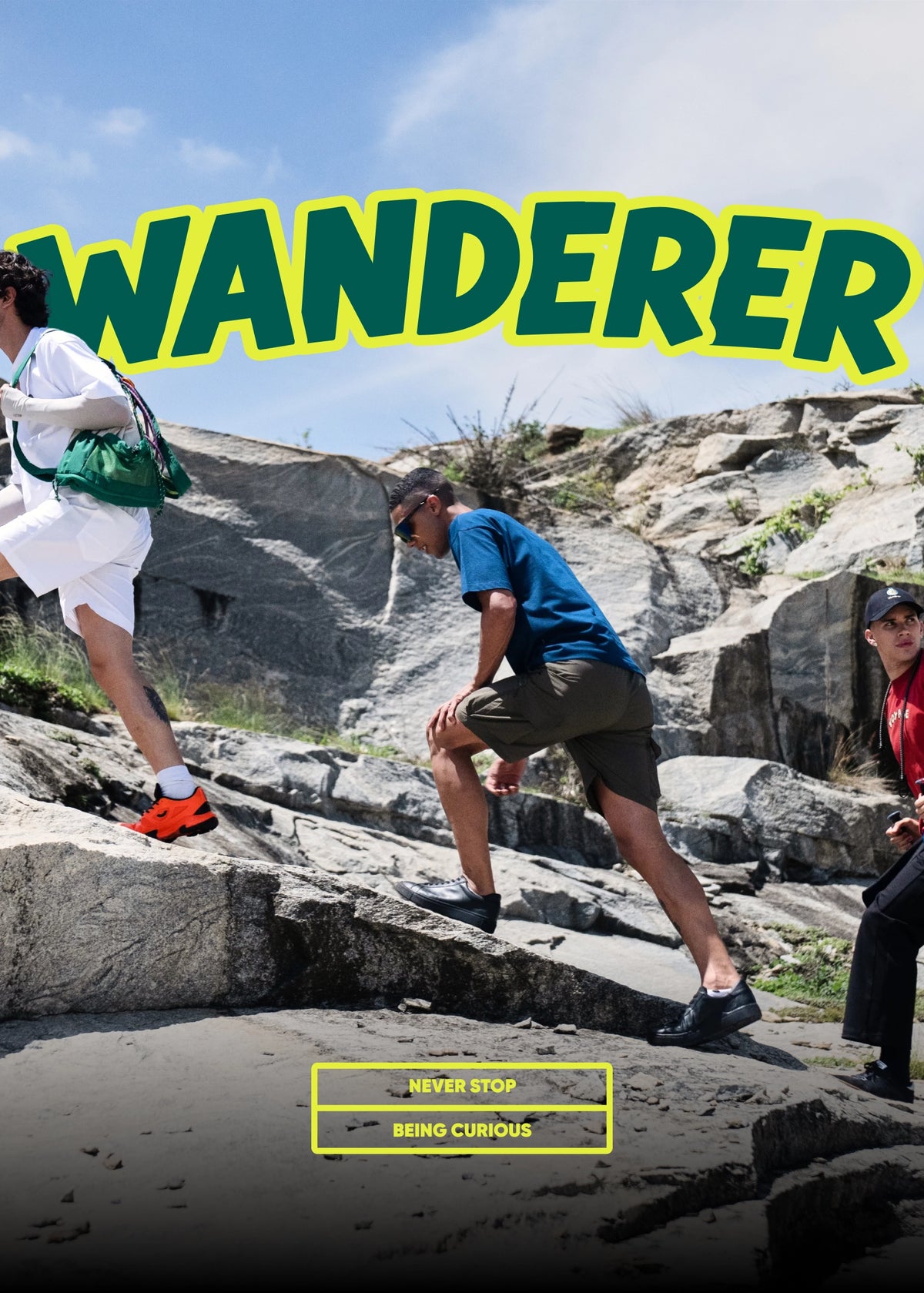 Outdoor promotional scene with three people hiking up rocky terrain under a blue sky. Large text at the top reads 'WANDERER' in green with a yellow outline, and smaller text at the bottom reads 'NEVER STOP' and 'BEING CURIOUS'.