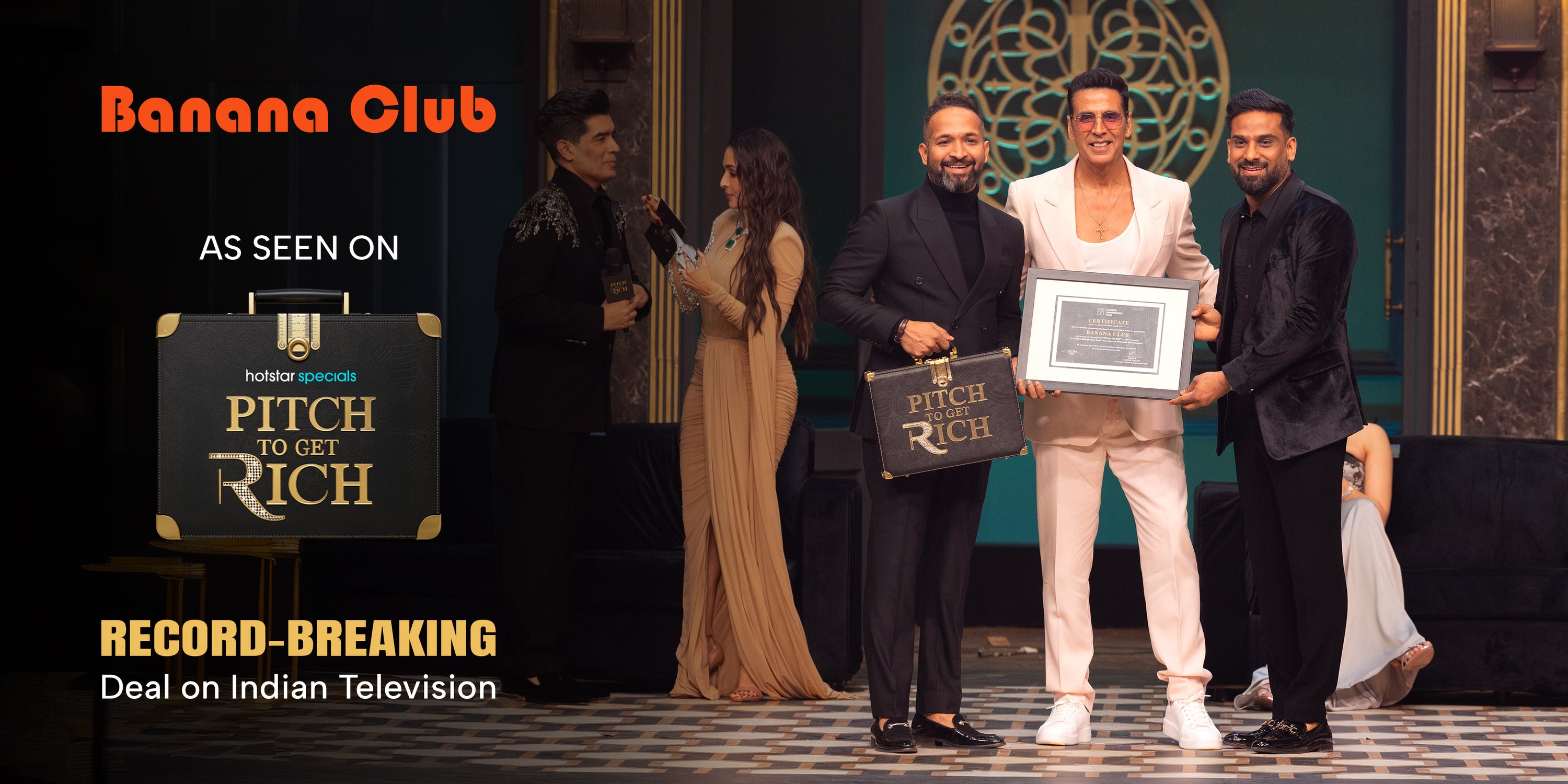 People on a stage holding an award with 'Banana Club' and 'Pitch to Get Rich' branding.