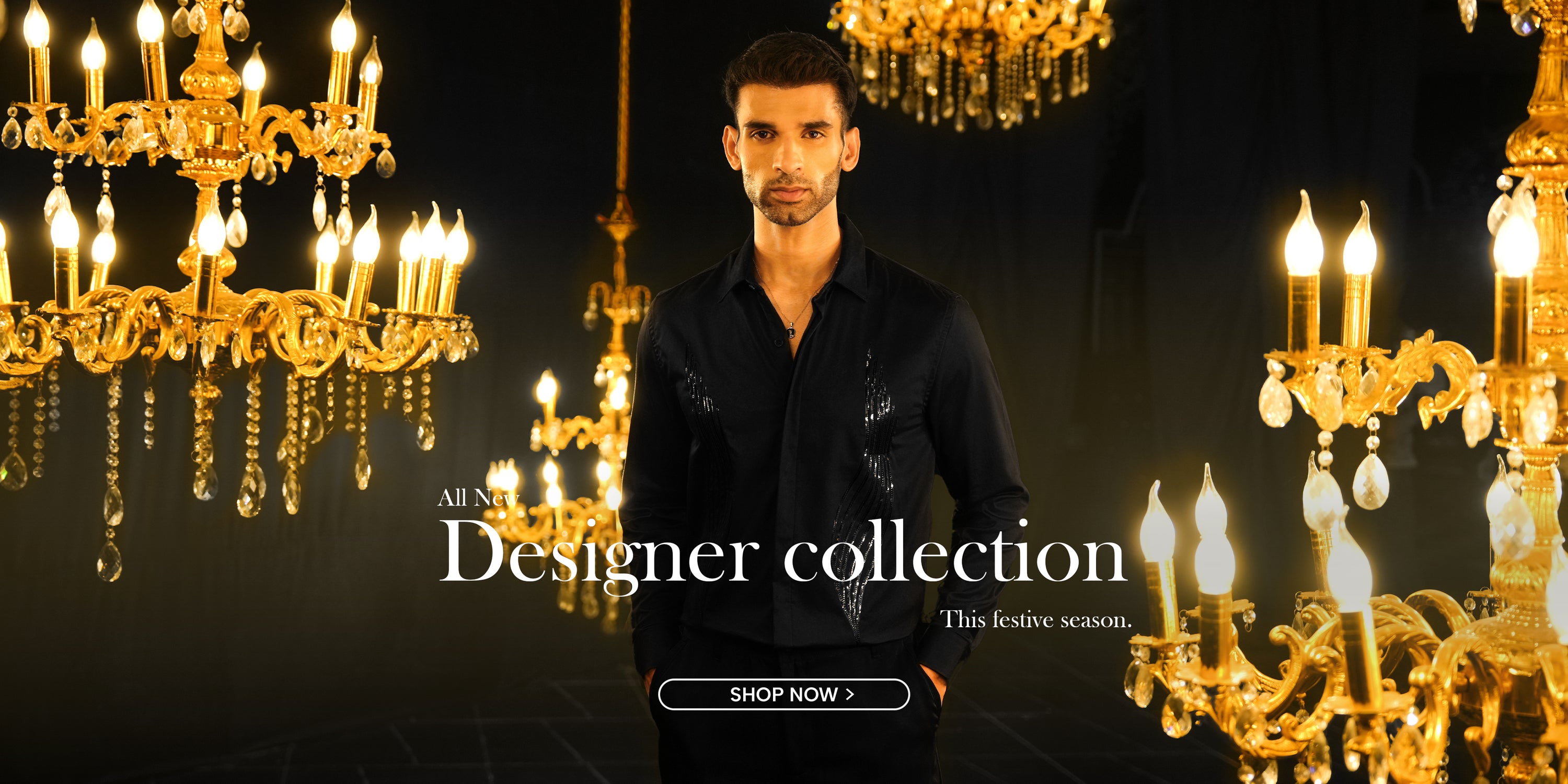 Man standing in front of chandeliers with promotional text for a designer collection.
