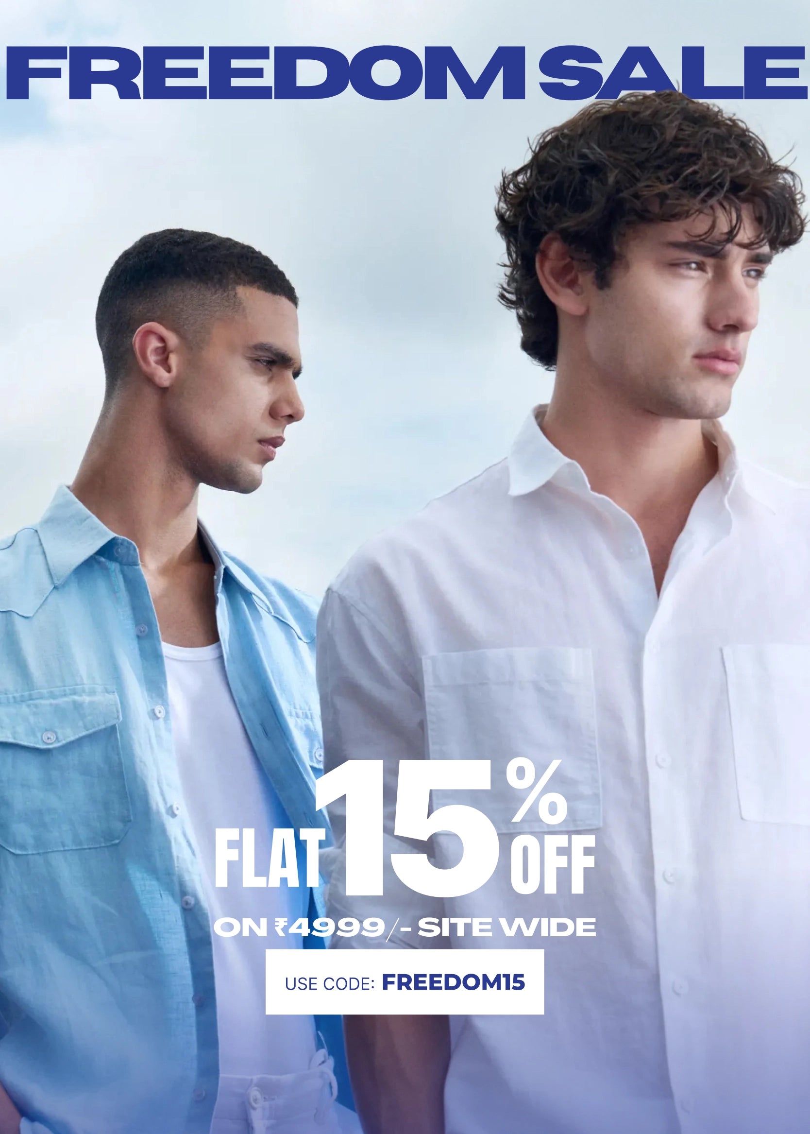 Promotional sale graphic featuring two male models wearing light blue and white button-down shirts against a pale sky background, with large text reading 'FREEDOM SALE' and 'FLAT 15% OFF ON 149.99+ SITE WIDE.