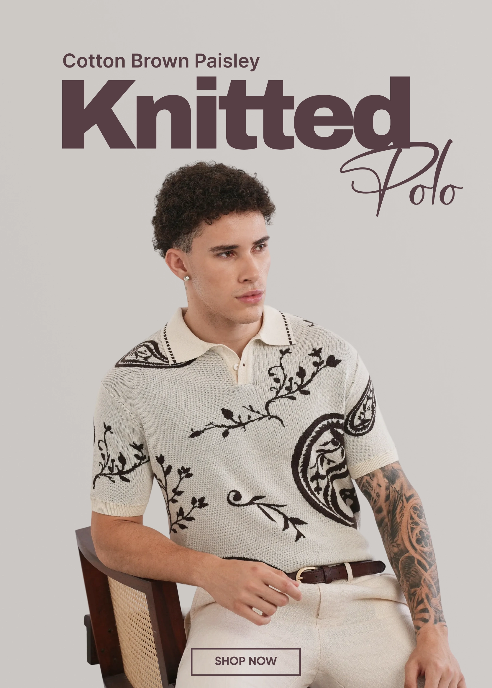 Man wearing a knitted polo shirt with paisley patterns on a gray background