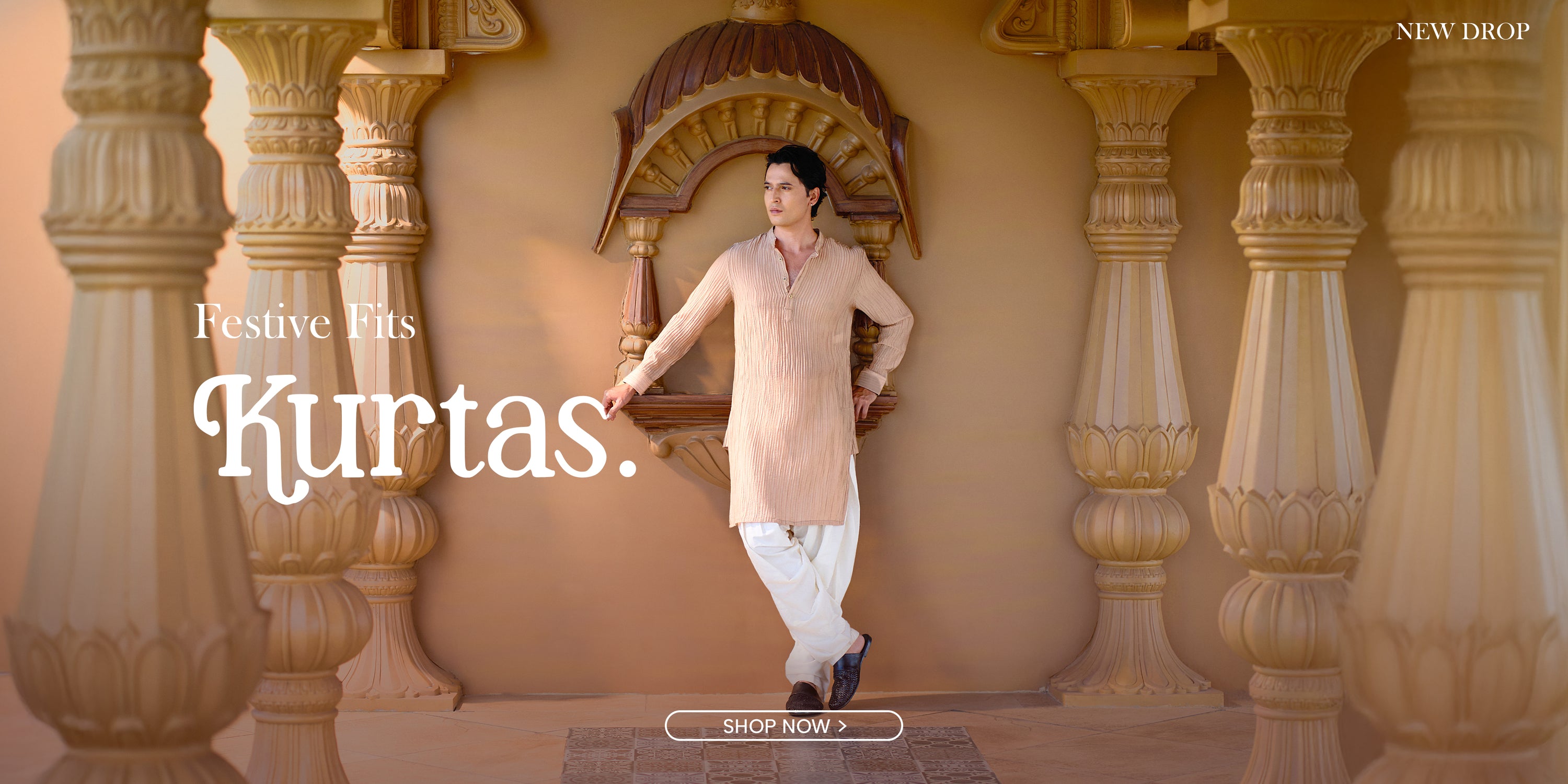 Man in a beige kurta standing in front of decorative pillars with text overlay on a beige background.