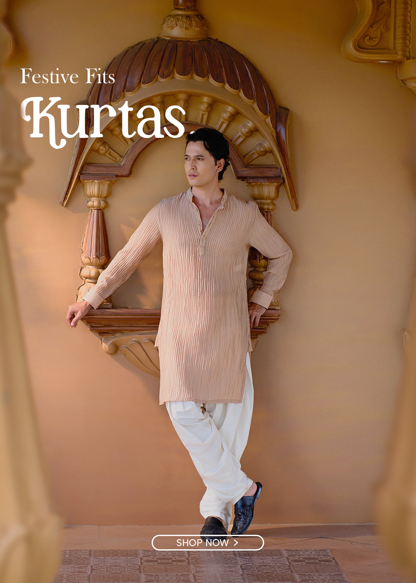 Man wearing a beige kurta with white pants in an ornate setting, promoting 'Festive Fits Kurtas'.