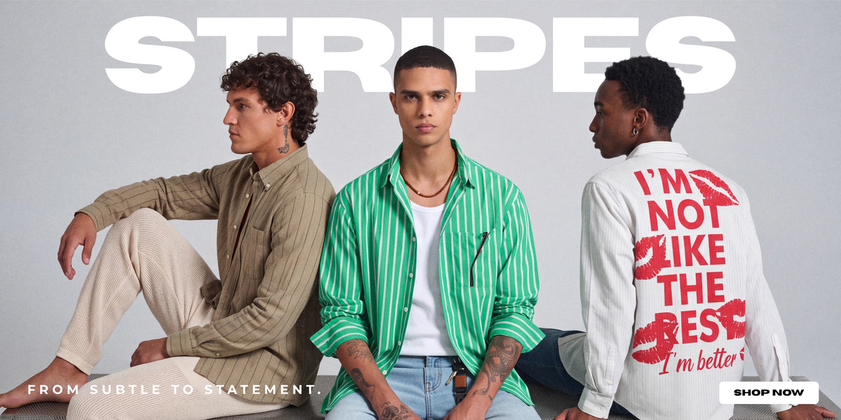 Three male models wearing striped and patterned shirts pose against a light gray studio background with large white 'STRIPES' text at the top. The center model wears a green-and-white vertically striped button-up shirt over a white T-shirt and light blue jeans.